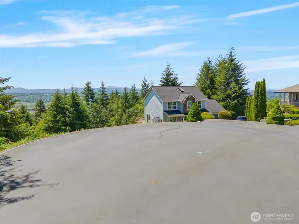 a house with a yard and a car park in the back