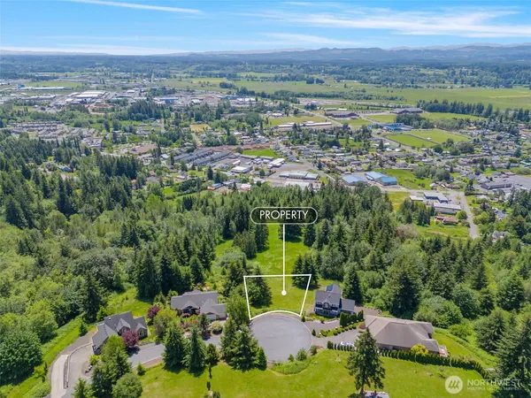 an aerial view of a houses with a yard