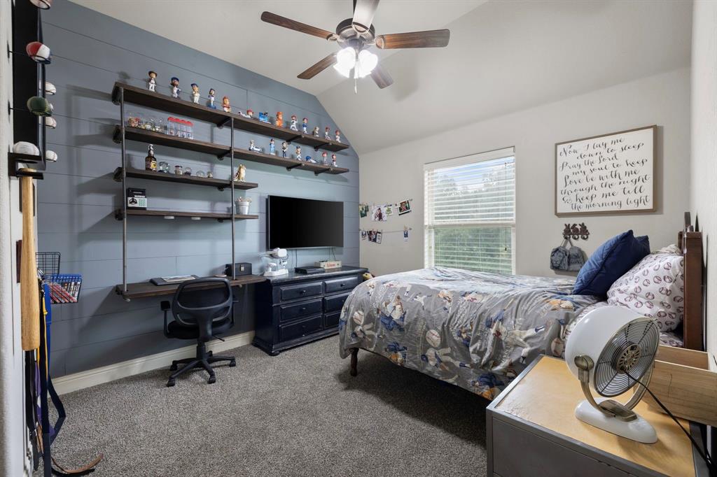 2103 Cash Point Court Granbury, TX 76049 - Photo 20 of 38 a bedroom with a bed and a flat screen tv