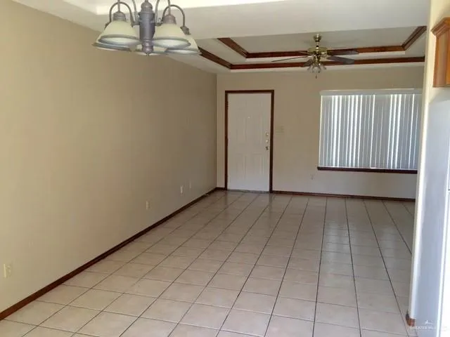a view of a livingroom with an empty space and a window