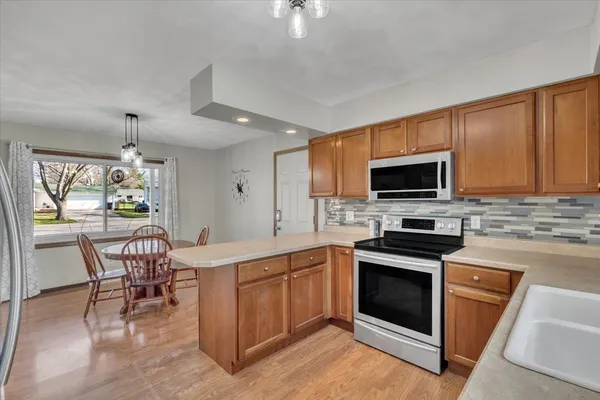 a kitchen with a stove a sink and a microwave