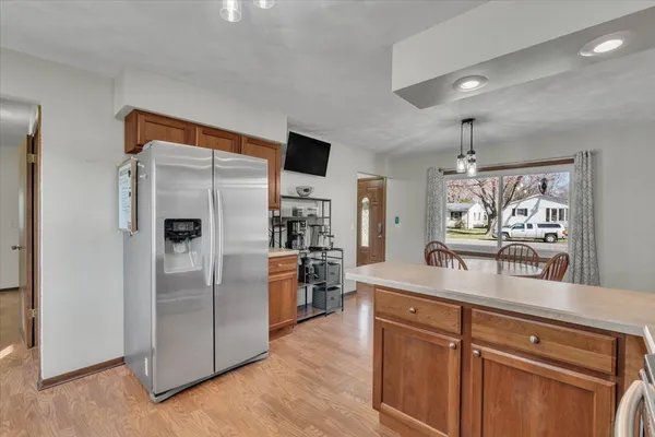 a kitchen with stainless steel appliances granite countertop a refrigerator and a sink