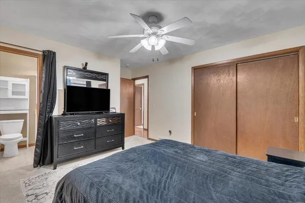 a bedroom with a bed and a flat screen tv