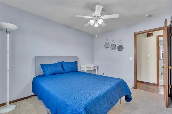 a bedroom with a large bed and a chandelier