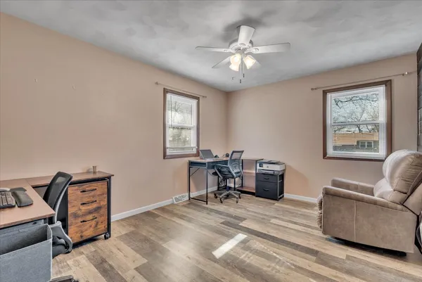 a view of a livingroom with furniture and a window