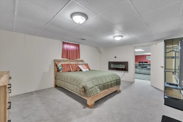 a spacious bedroom with a bed couch and a window