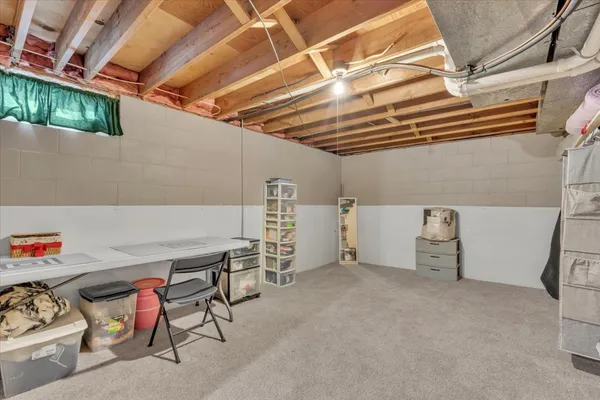 a view of a storage room with a fridge