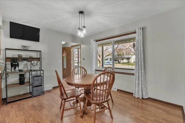 a view of a dining room with furniture window and wooden floor
