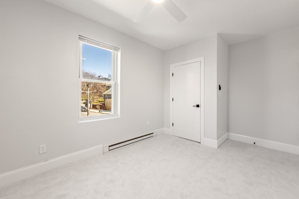 113 Regent Street Boston, MA 02119 - Photo 13 of 18 an empty room with windows