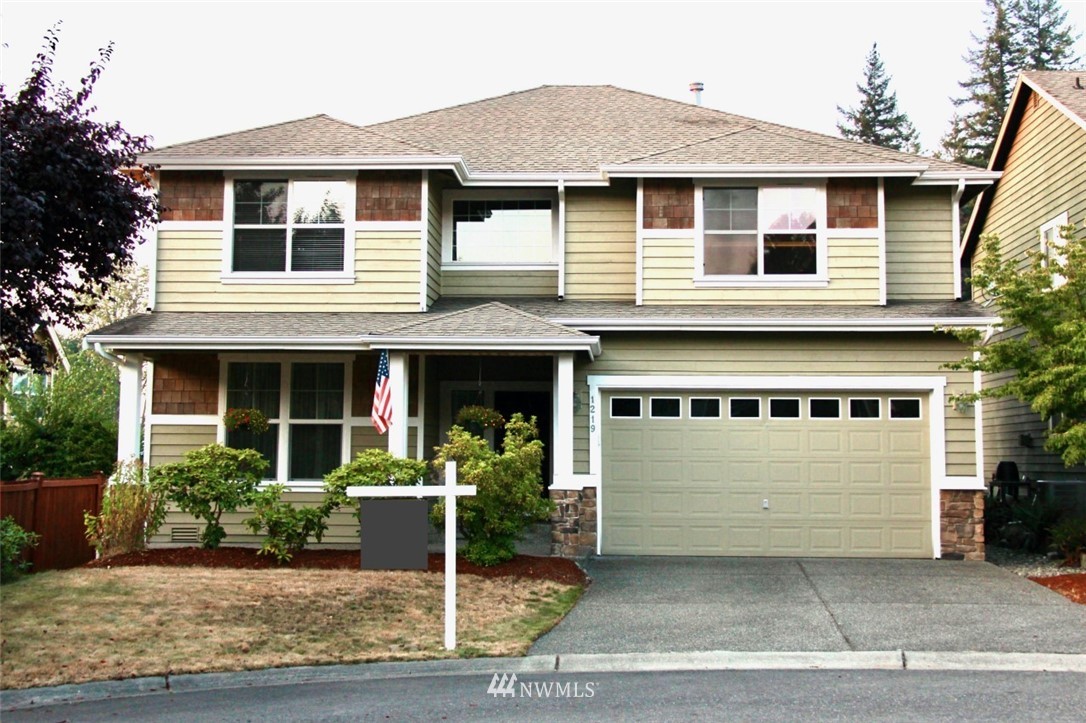 1219 187th Street Southeast Bothell, WA 98012 - Photo 1 of 39 a front view of a house with garden
