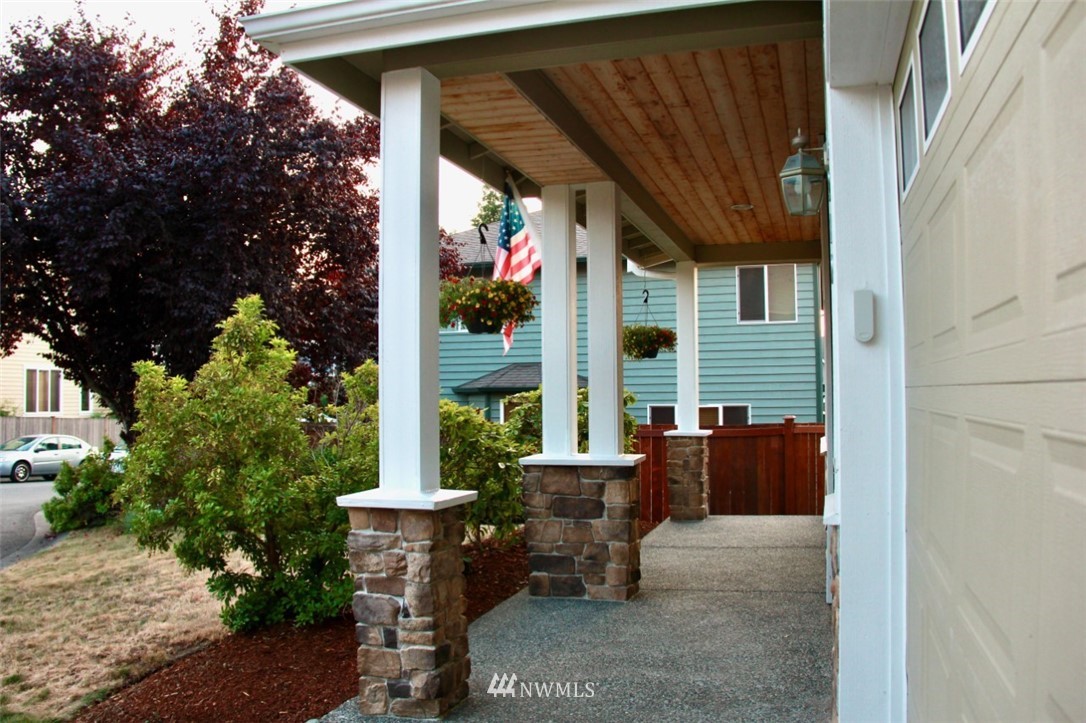 1219 187th Street Southeast Bothell, WA 98012 - Photo 2 of 39 a view of patio with a table and chairs and potted plants
