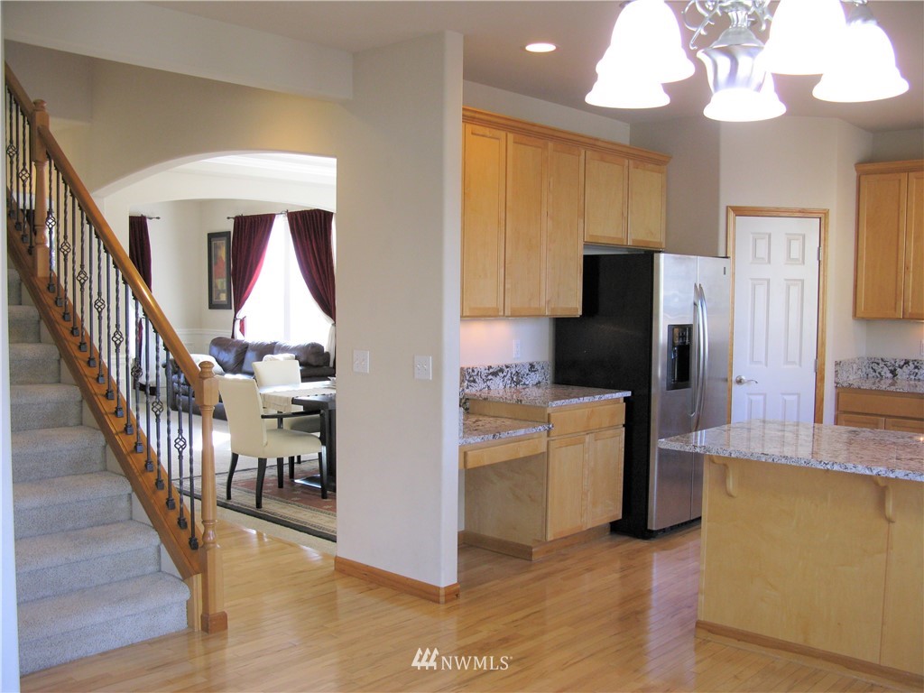 1219 187th Street Southeast Bothell, WA 98012 - Photo 11 of 39 a kitchen with stainless steel appliances granite countertop a refrigerator and a stove top oven