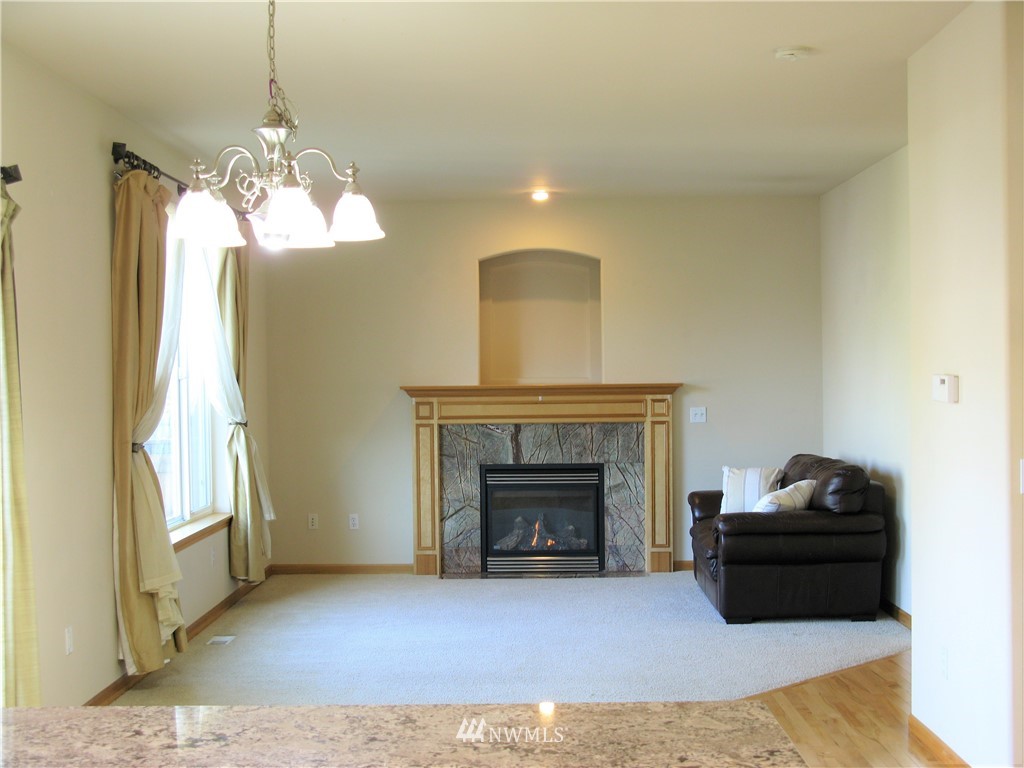 1219 187th Street Southeast Bothell, WA 98012 - Photo 17 of 39 a living room with furniture and a fireplace
