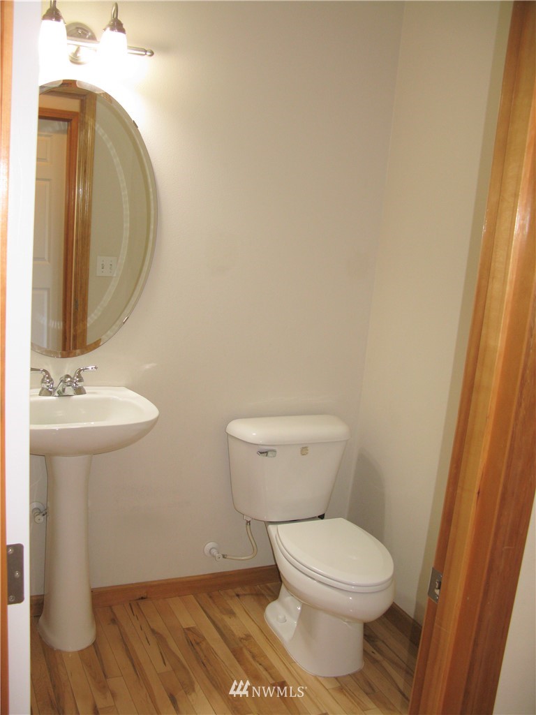 1219 187th Street Southeast Bothell, WA 98012 - Photo 19 of 39 a white toilet sitting next to a bathroom sink