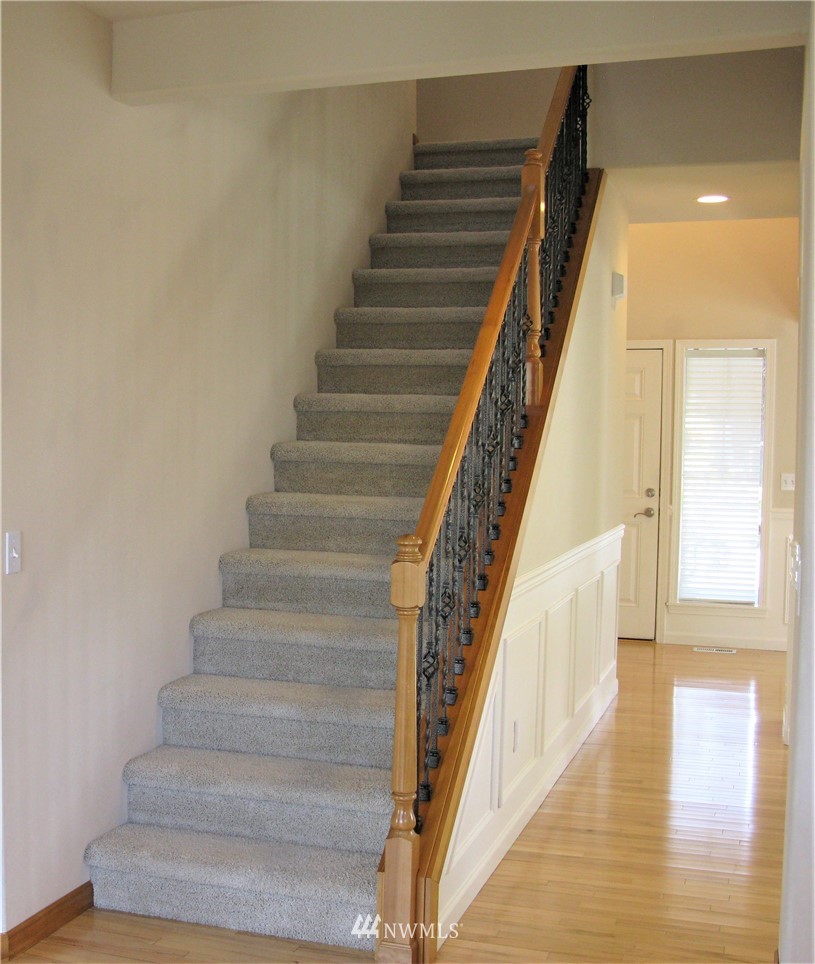 1219 187th Street Southeast Bothell, WA 98012 - Photo 21 of 39 a view of staircase with wooden floor and a rug