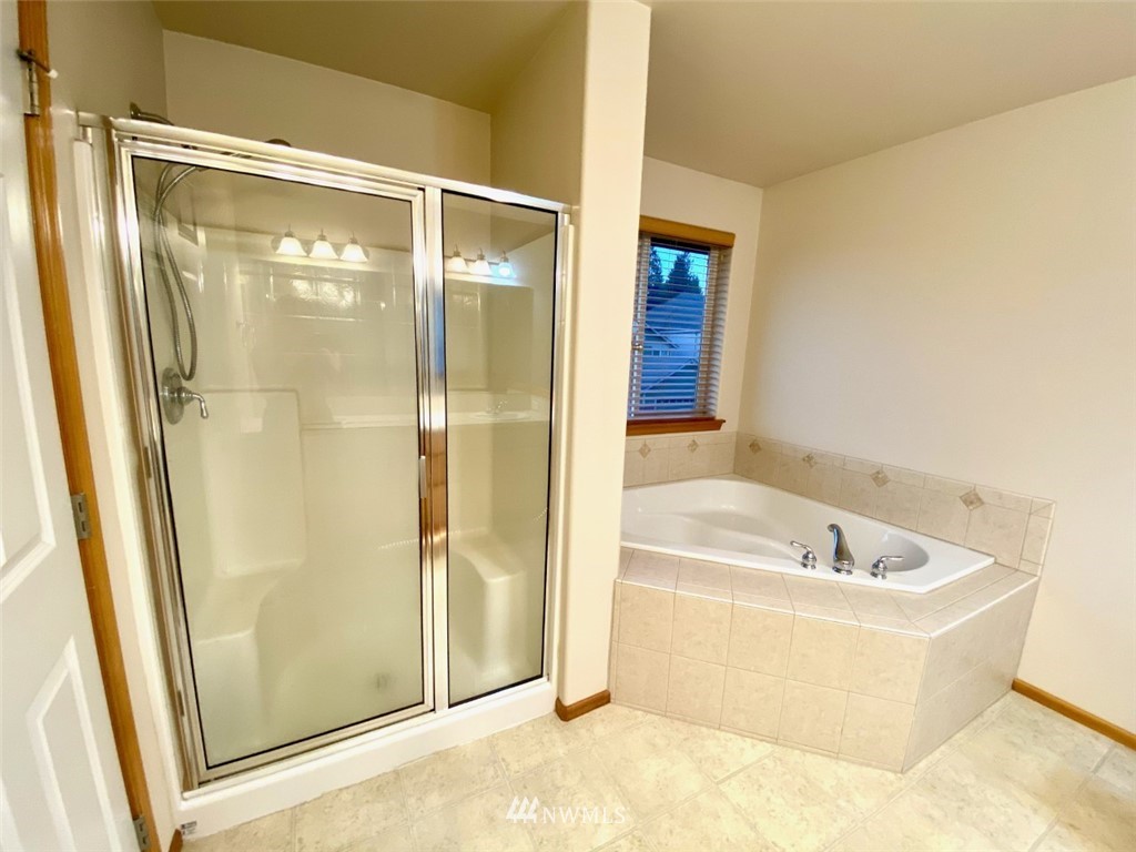 1219 187th Street Southeast Bothell, WA 98012 - Photo 28 of 39 a bathroom with a bathtub and a shower