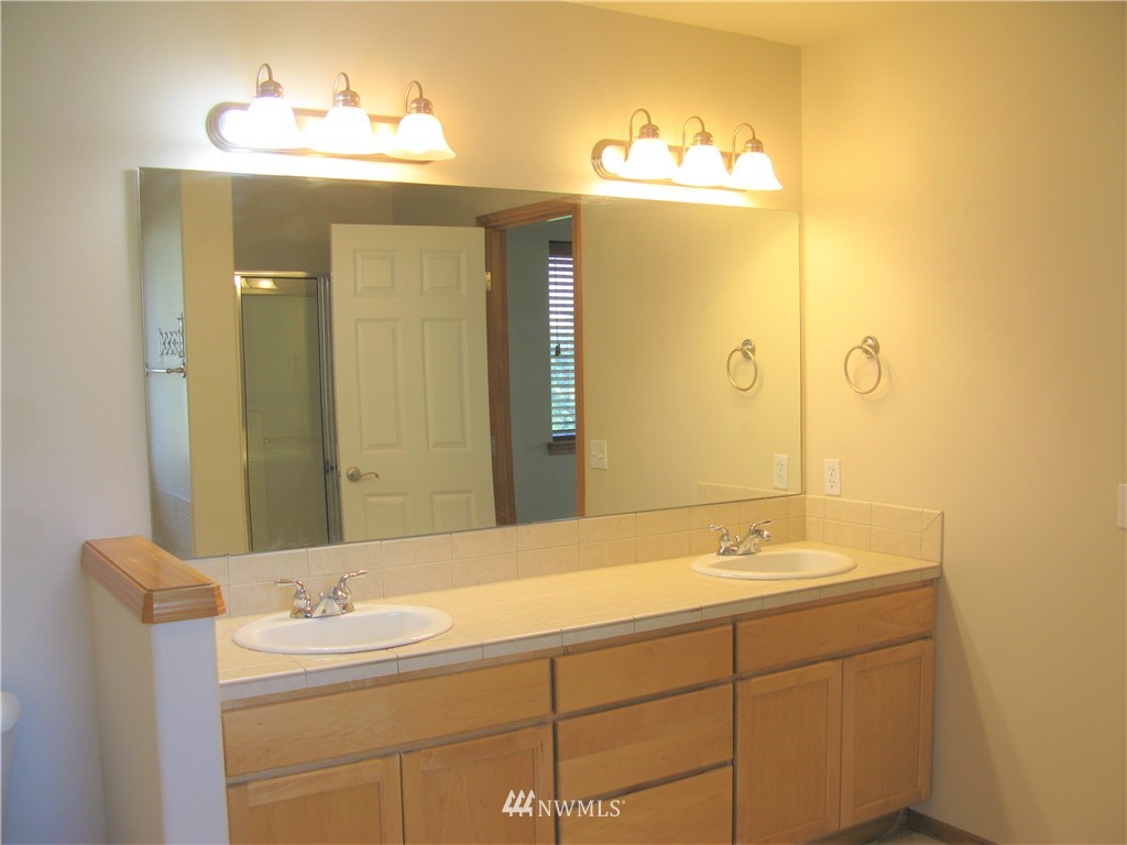 1219 187th Street Southeast Bothell, WA 98012 - Photo 29 of 39 a bathroom with a double vanity sink and a mirror