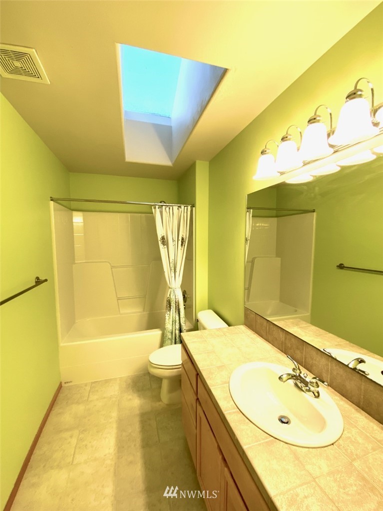 1219 187th Street Southeast Bothell, WA 98012 - Photo 35 of 39 a bathroom with a granite countertop sink and a mirror