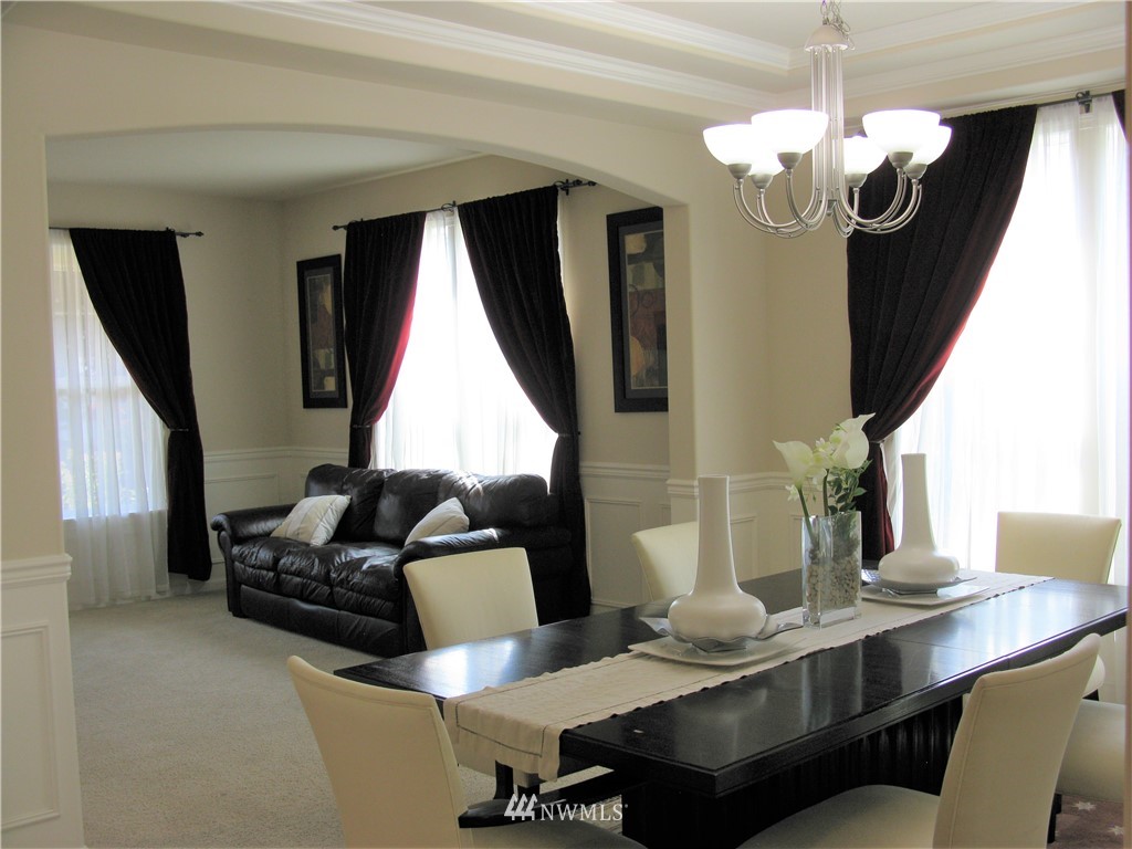 1219 187th Street Southeast Bothell, WA 98012 - Photo 8 of 39 a dining room with furniture a chandelier and window