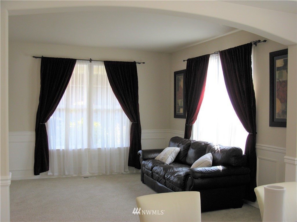 1219 187th Street Southeast Bothell, WA 98012 - Photo 9 of 39 a living room with furniture and a large window