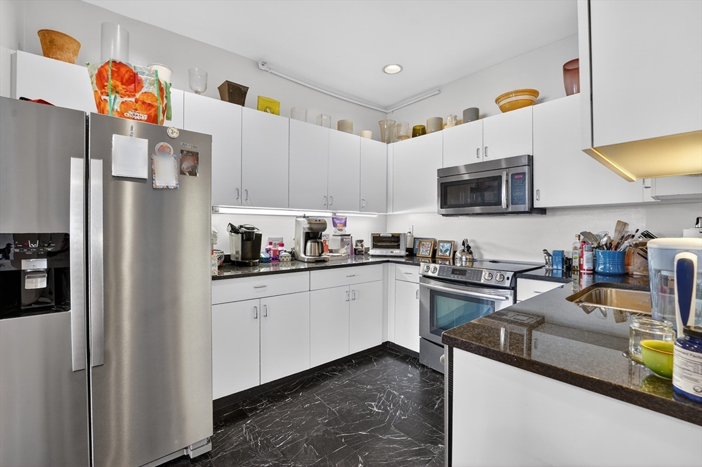 290 Beacon Street, Unit 4 Boston, MA 02116 - Photo 3 of 12 a kitchen with a sink a refrigerator and a stove top oven