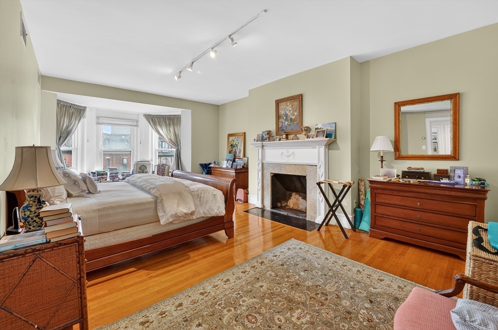 290 Beacon Street, Unit 4 Boston, MA 02116 - Photo 6 of 12 a bed room with a bed and a fireplace