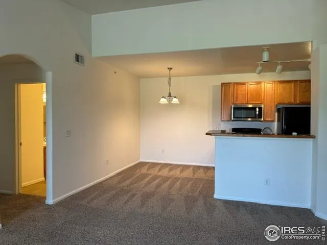 a kitchen with a refrigerator and a stove