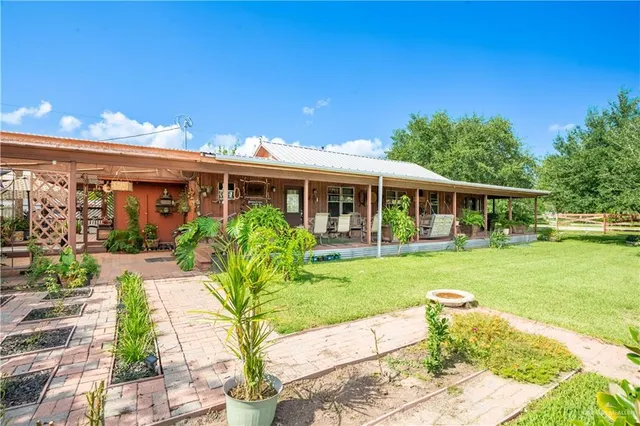 a view of a house with a yard porch and sitting area