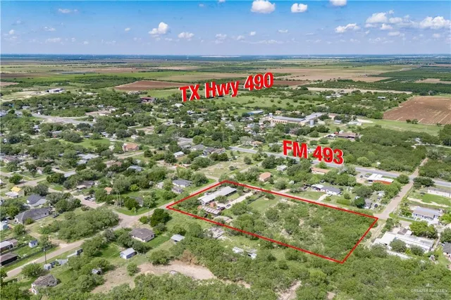 a view of a field with an ocean view