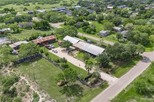 an aerial view of a house with a yard