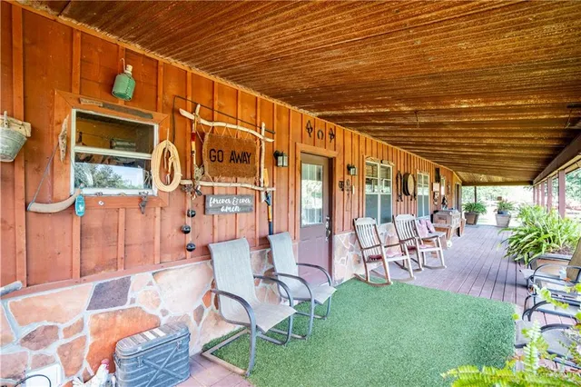 a view of a patio with table and chairs and potted plants