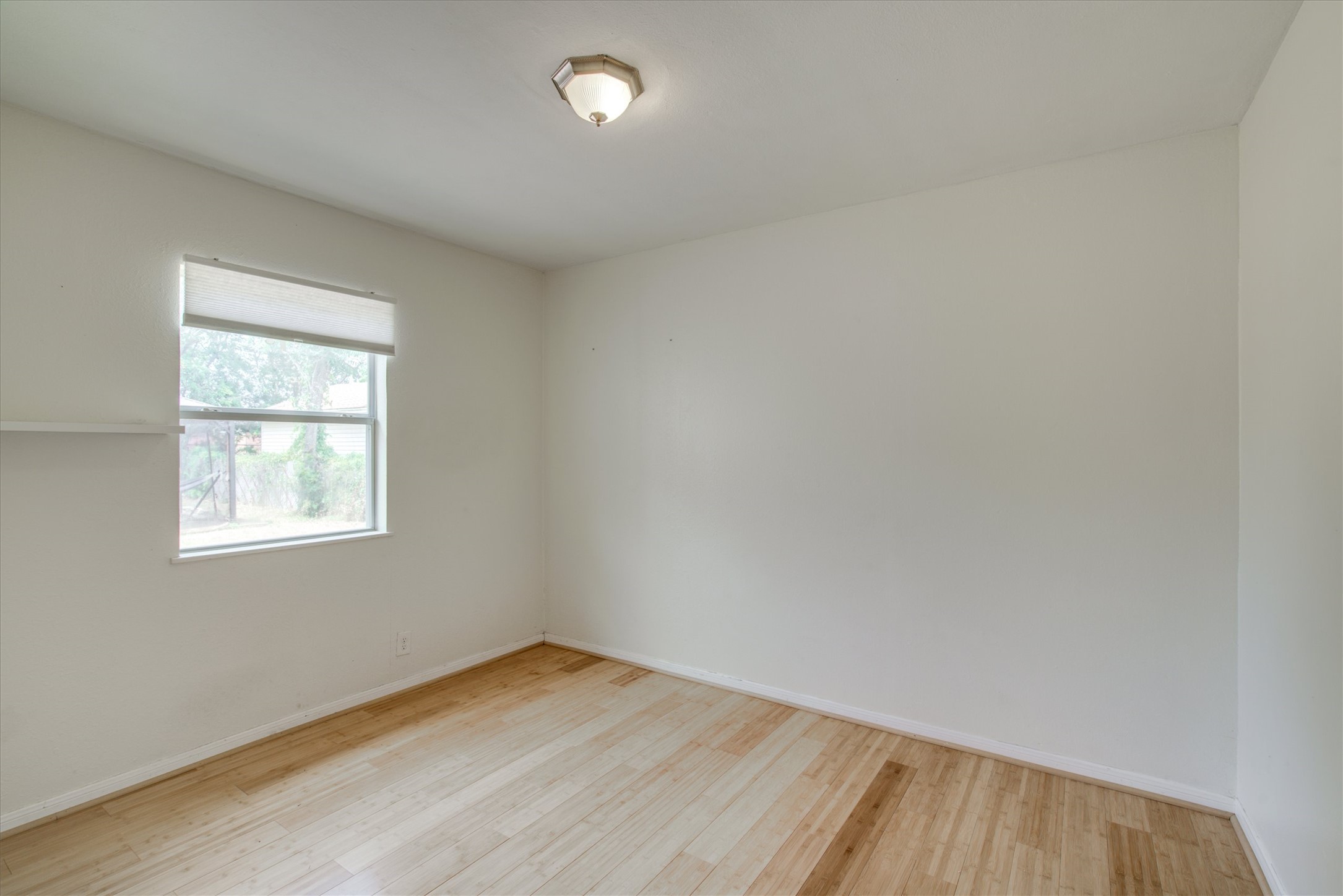 4615 Ribbecke Avenue Austin, TX 78721 - Photo 15 of 19 Unfurnished room with light wood-type flooring and baseboards