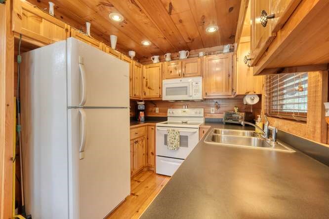 76 Channing Hollow Morganton, GA 30560 - Photo 11 of 47 a kitchen with stainless steel appliances a refrigerator sink and cabinets
