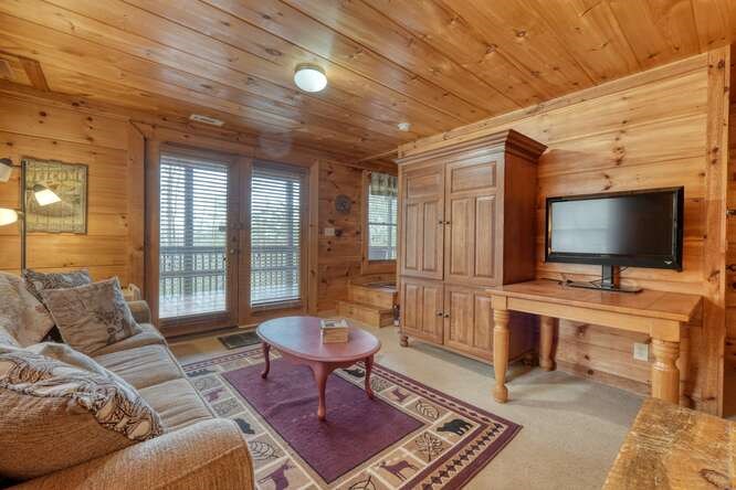 76 Channing Hollow Morganton, GA 30560 - Photo 26 of 47 a living room with furniture a flat screen tv and a table