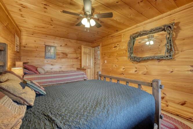 76 Channing Hollow Morganton, GA 30560 - Photo 29 of 47 a bedroom with a bed and ceiling fan