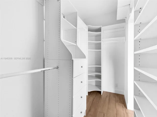 a bathroom with a granite countertop sink toilet and mirror