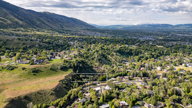 1365 Sumac Drive Logan, UT 84321 - Photo 47 of 66 Aerial perspective showcasing a residential area amidst a mountainous landscape with distant snow-capped peaks