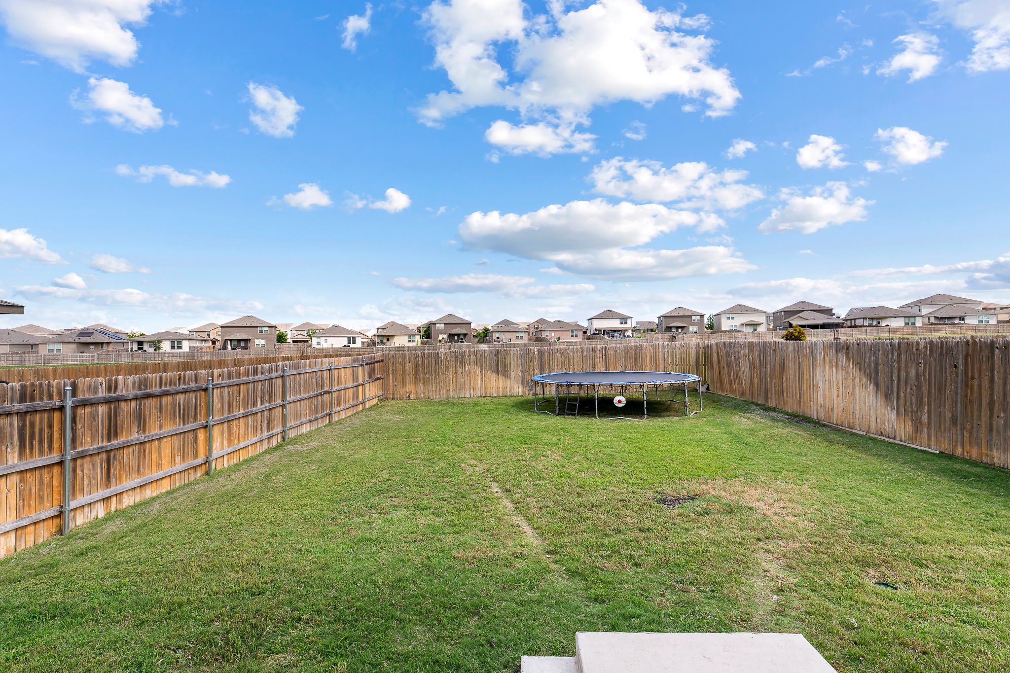 576 Greatest Gift Way Jarrell, TX 76537 - Photo 29 of 37 A spacious, enclosed green lawn offers an ideal setting for recreation and outdoor enjoyment.