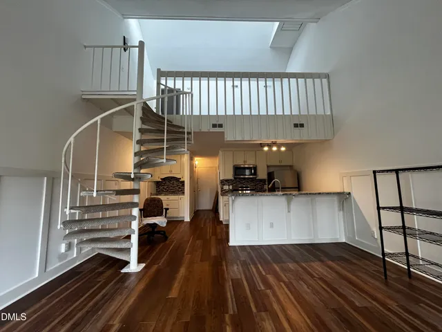 a view of a living room and entryway with wooden floor