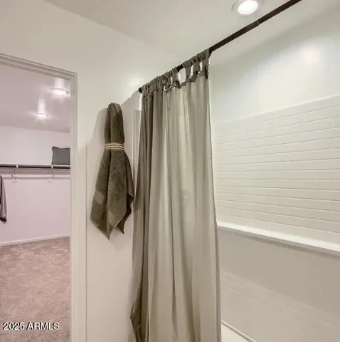 a bathroom with a granite countertop sink a mirror and shower