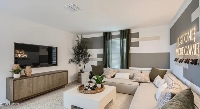 a living room with furniture and a chandelier