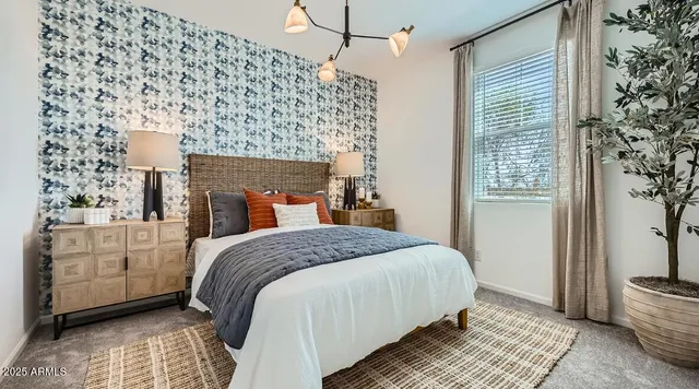 a bedroom with a bed and a chandelier