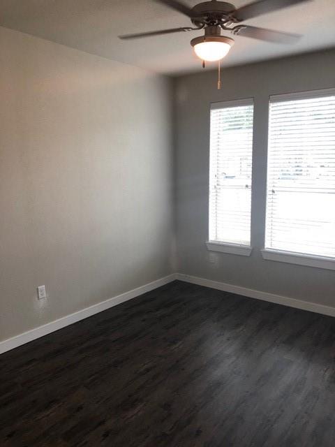 2309 North Elm Street Denton, TX 76201 - Photo 4 of 8 a view of an empty room with wooden floor and a window