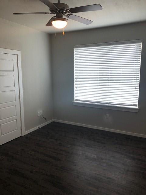 2309 North Elm Street Denton, TX 76201 - Photo 6 of 8 an empty room with wooden floor and windows