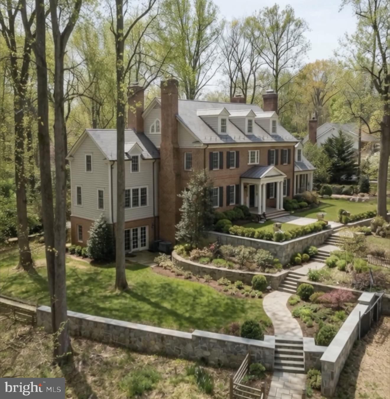 0 Linway Terrace McLean, VA 22101 - Photo 2 of 14 a view of a white house next to a yard with large trees