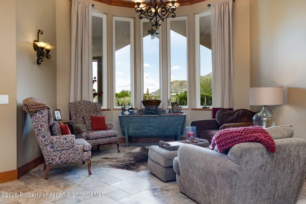 a living room with furniture and a large window