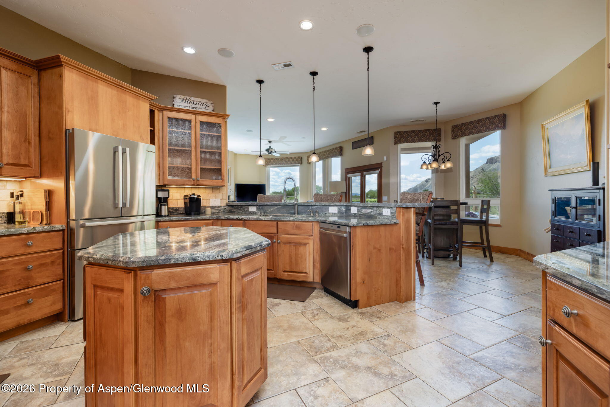 759 36 3/10 Road Palisade, CO 81526 - Photo 20 of 38 a kitchen with kitchen island granite countertop a sink a counter top space appliances and cabinets