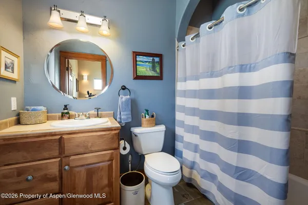 a bathroom with a sink mirror and toilet