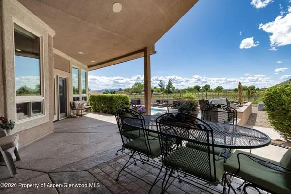 a view of a chairs and table in patio