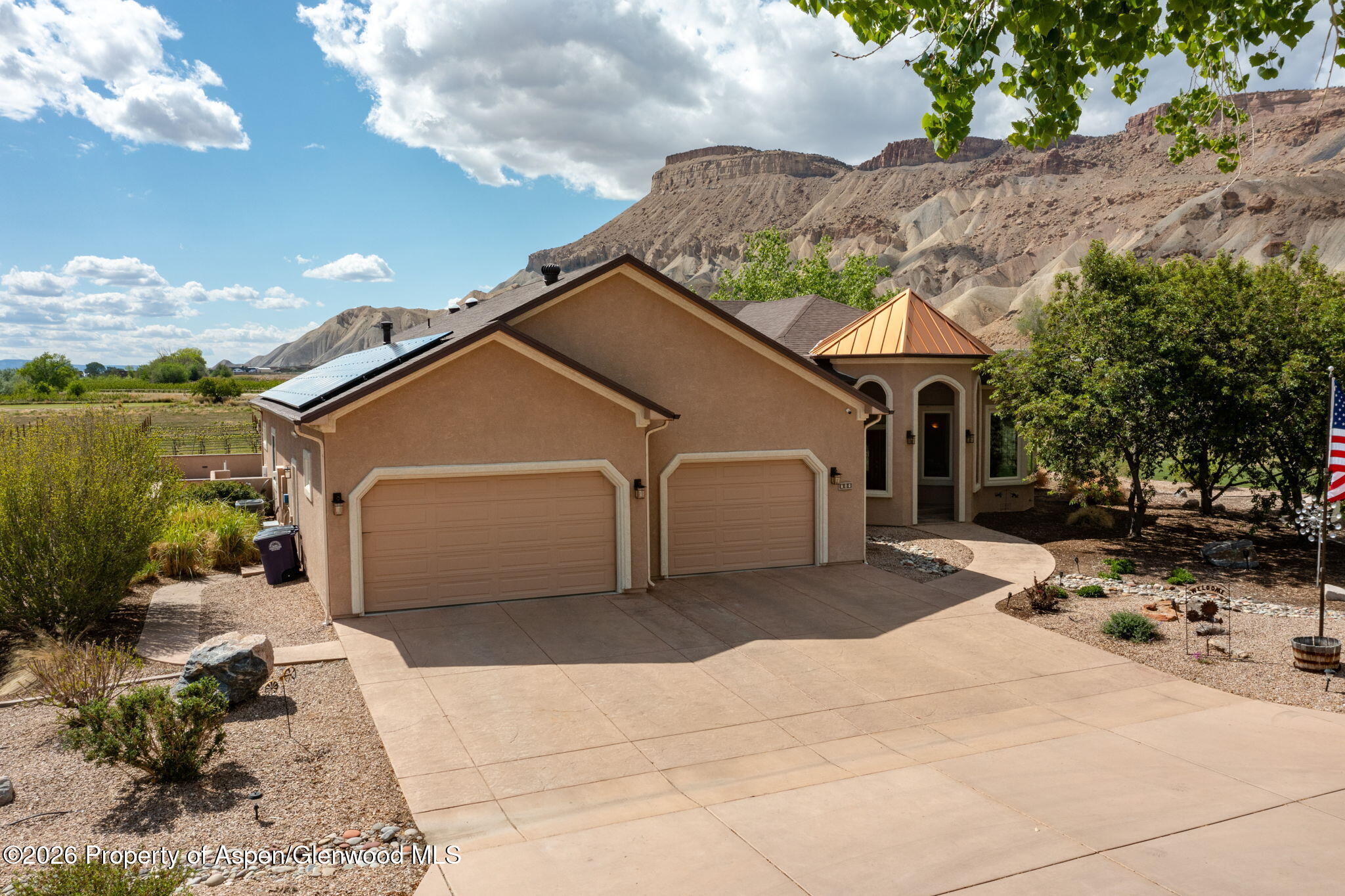 759 36 3/10 Road Palisade, CO 81526 - Photo 3 of 38 a front view of a house with a yard and garage
